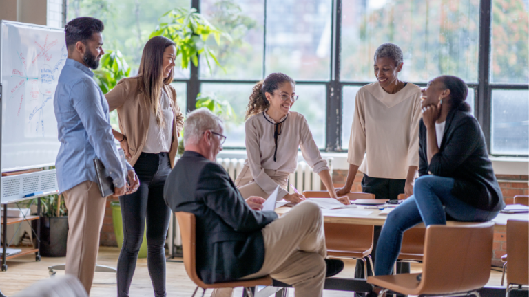 Team gathered around a table in a bright office