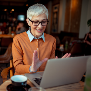Woman working on a laptop with a cup of coffee