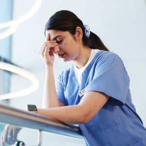 Stressed nurse looking at her phone